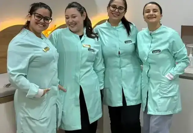 Equipe da NH Vacinas com uniformes mint sorrindo juntas